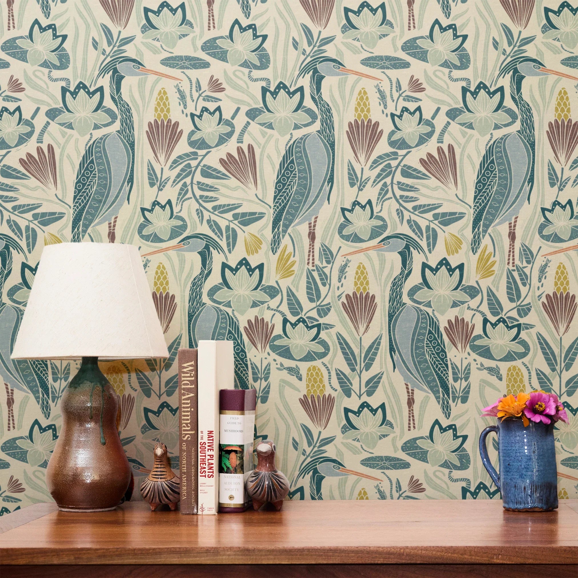 Decorative pattern with blue birds, lotus flowers, and foliage in muted teal, mauve, and cream tones