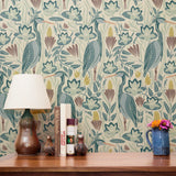 Decorative pattern with blue birds, lotus flowers, and foliage in muted teal, mauve, and cream tones