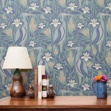 Art Nouveau floral pattern with white lilies, blue-green leaves and decorative pods on blue backgrou