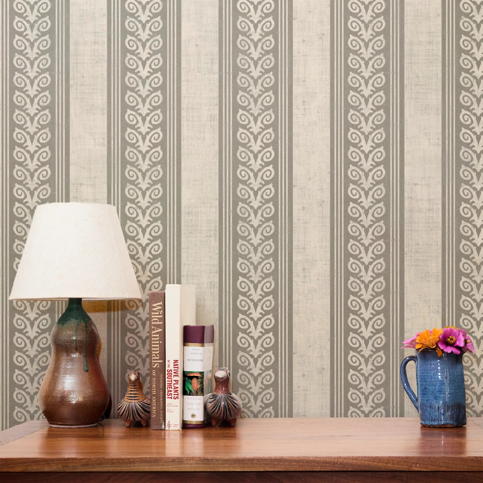 Vertical stripes pattern in beige and white with decorative scrollwork motifs alternating with plain