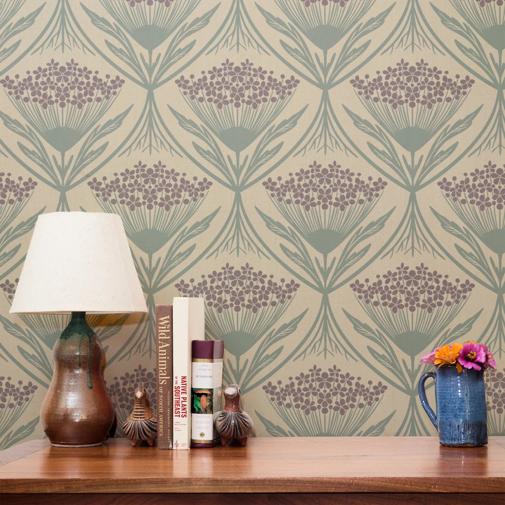 Art Nouveau wallpaper pattern with stylized flowers in purple and teal on beige background