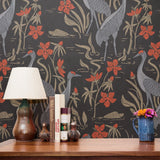 Decorative pattern with gray herons, red flowers, and beige foliage on dark background