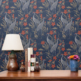 Blue wallpaper pattern with white herons, coral flowers, and green foliage in an Art Nouveau style