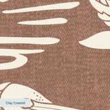 Tropical bird and palm leaf pattern in cream on terracotta brown background
