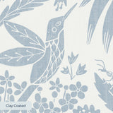 Symmetrical botanical pattern with stylized flowers, leaves, and moths in soft blue-gray on cream ba