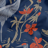 Herons amid flowering plants on navy blue background, decorative pattern with coral blooms and folia