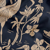 Elegant herons and cranes with flowers in beige on dark navy blue background, nature pattern