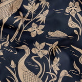 Cranes and flora pattern in beige on dark blue background with Asian-inspired design