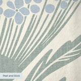 Art Nouveau floral pattern with stylized blue flowers and sage green leaves on cream background