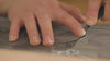 A vide of Katie's hands carving a humming bird print, mixing inks, and pulling a final block print of palm leaves. 
