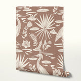 Tropical bird and palm leaf pattern in cream on terracotta brown background