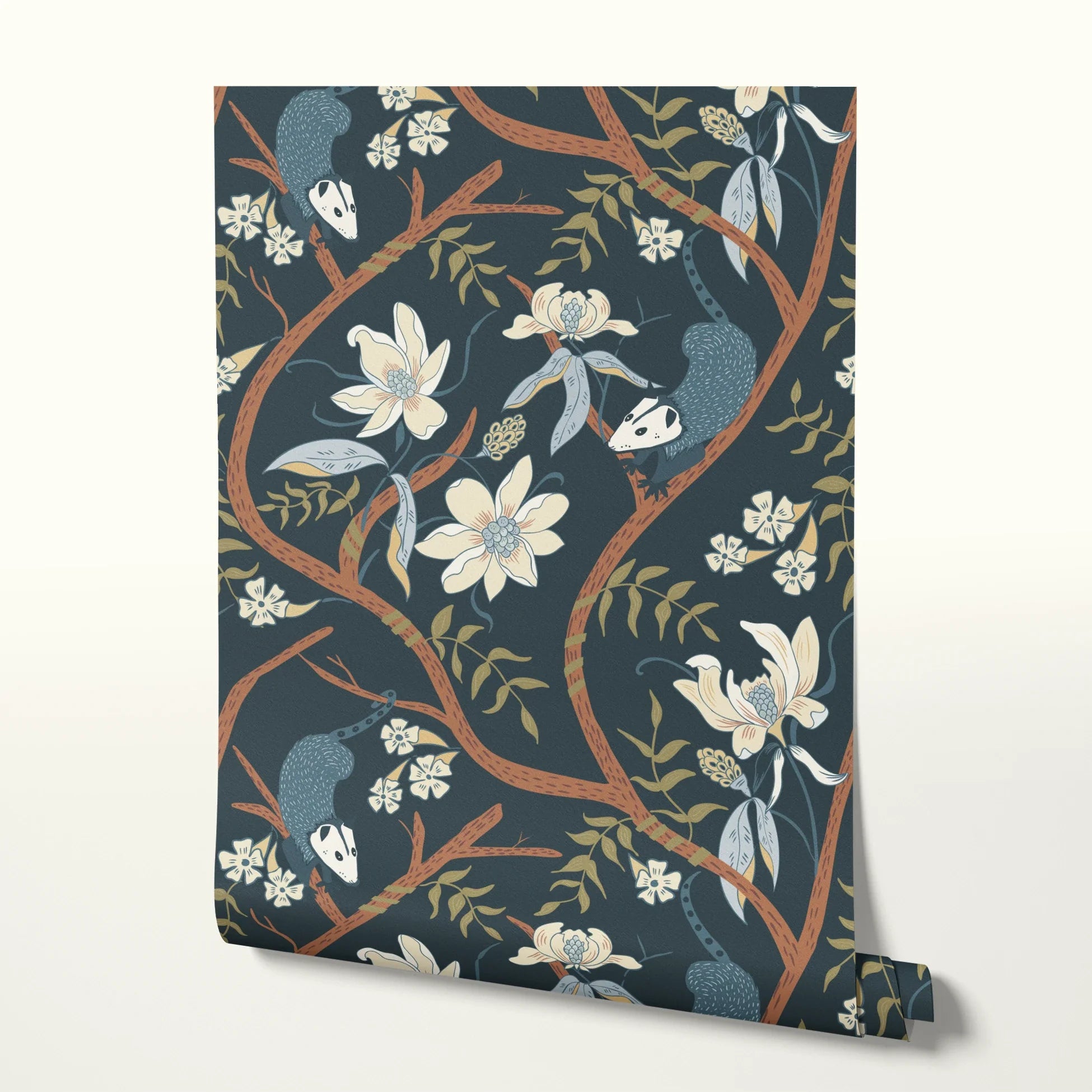 Dark floral pattern with cream magnolias, blue berries, green leaves and brown branches on black bac