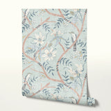Delicate floral pattern with white flowers, blue-gray leaves, and coral branches on pale blue backgr
