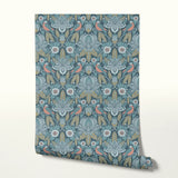 Symmetrical art nouveau pattern with stylized birds, lotus flowers, and foliage in blue, coral, and