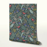 Dense floral pattern with red birds, tropical leaves, flowers and berries on dark teal background
