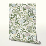 Decorative botanical pattern with green ferns, leaves, mushrooms, and flowers on cream background