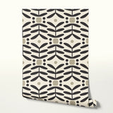 Geometric pattern with black botanical motifs and tan circles on cream background