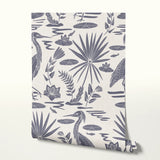 Tropical botanical pattern with blue herons, palm fronds, and foliage on cream background