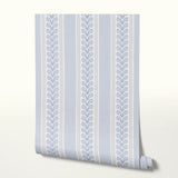 Blue and white vertical striped pattern with decorative floral motifs