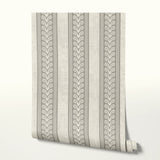 Vertical stripes pattern in beige and white with decorative scrollwork motifs alternating with plain