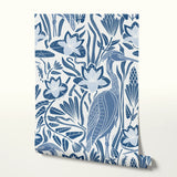 Blue and white decorative pattern with birds, flowers, and foliage in folk art style
